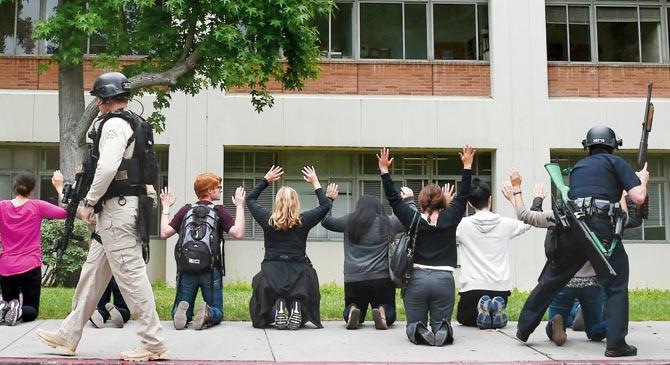 Students and others are searched by security officers after a campus shooting on Wednesday at the UCLA campus. Pic/AFP