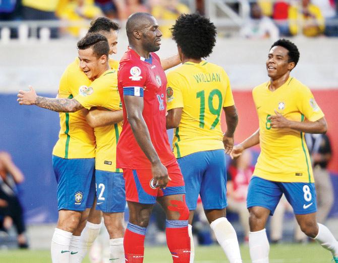 yellow fever in USA: Brazil’s Philippe Coutinho (second from left) celebrates with teammates after scoring in a Copa America match against Haiti in Orlando, USA on Wednesday. Coutinho scored thrice as the Brazilians won 7-1. pic/AFP