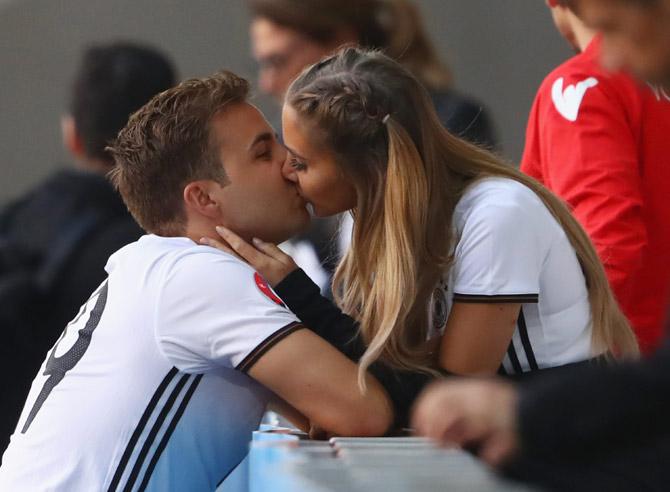 Mario Goetze and girlfriend Ann-Kathrin Broemmel share a kiss