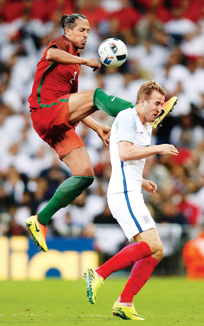 Portugal defender Bruno Alves (left) fouls England striker Harry Kane to receive a red card during the friendly football match between England and Portugal at Wembley in London on Friday. pic/AFP