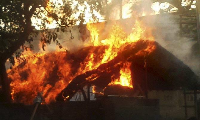 A house is set on fire after clashes between the police and the encroachers who were being evicted from Jawaharbagh in Mathura