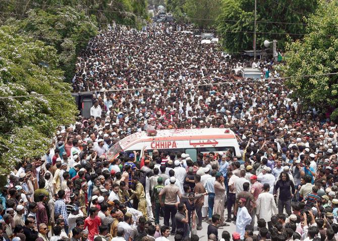 Thousands of people attended the funeral procession of Amjad Sabri, killed when unidentified gunmen open fire on his car in Karachi, on June 23. Pic/AFP