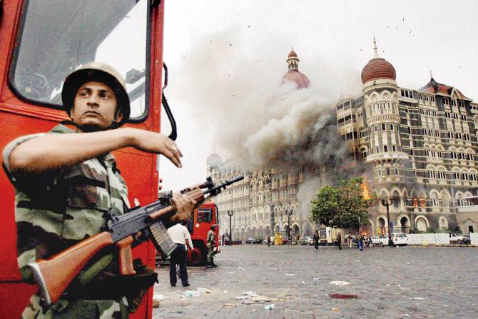Smoke is seen billowing out of the ground and first floor of the Taj Mahal Hotel in south Mumbai during security personnel’s “Operation Cyclone” following the 26/11 terror attacks in 2008. File pic/PTI