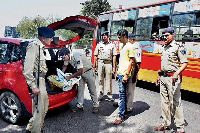 taking no chances: Police check a vehicle in Ahmedabad after a high alert was sounded across Gujarat yesterday. The state home department has beefed up security in the state following the warning of a possible terror attack. PIC/PTI
