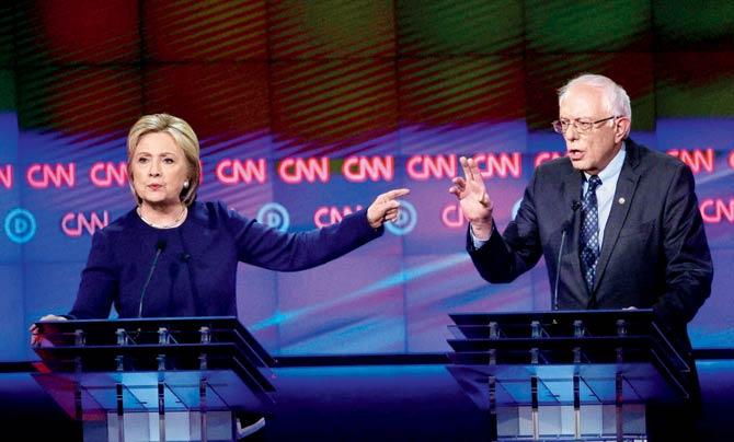 Hillary Clinton and Bernie Sanders at the debate in Michigan. Pic/AFP