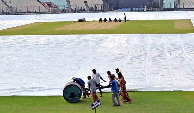 Groundsmen busy in final preparations of the pitch at Eden Gardens in Kolkata on Monday ahead of upcoming T20 Cricket World Cup match. Pic/PTI