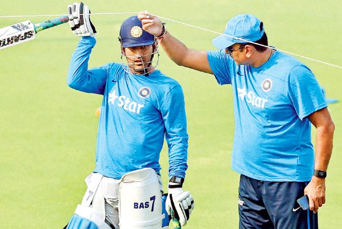 Team Director Ravi Shastri with skipper Mahendra Singh Dhoni during a practice session at Eden Gardens in Kolkata yesterday. Pic/PTI