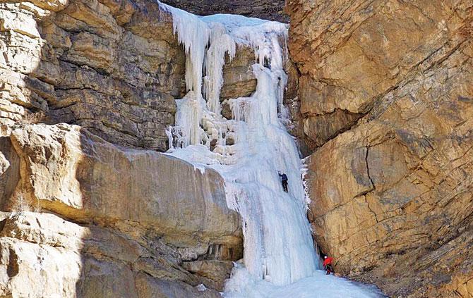 The climbers (spot the dots) ascend the 260-feet high frozen Shela waterfall