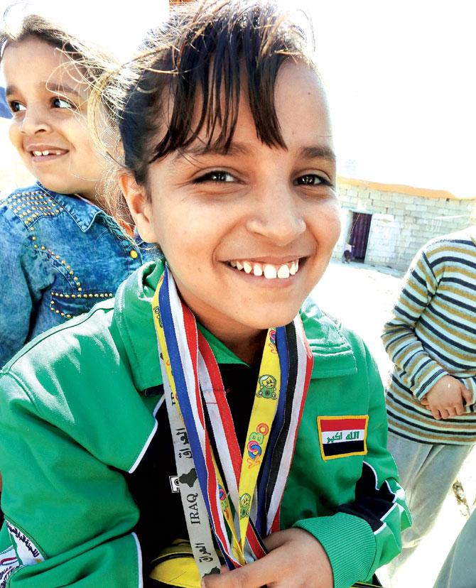 Nejla Imad with her table tennis medals in Baquba. Pic/AFP
