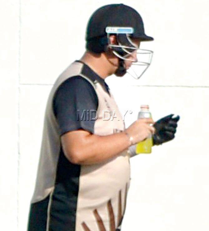 NZ batting coach Craig McMillan wears a helmet at nets yesterday 