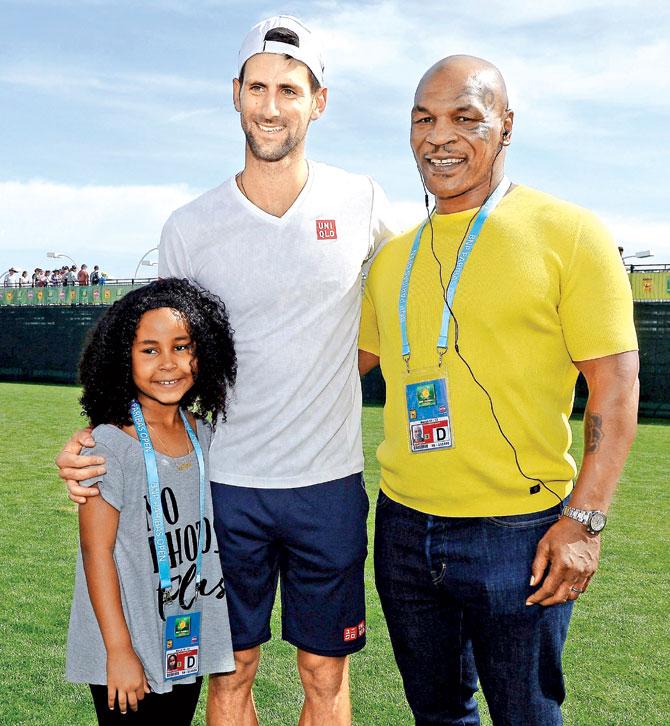 Surprise spectator: Mike Tyson (right) and his daughter Milan (left) meet Novak Djokovic at Indian Wells. Pics: Getty Images/AFP
