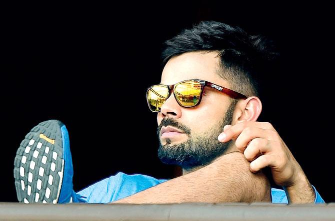Relaxed & ready: Virat Kohli watches teammates during a training session on the eve of India