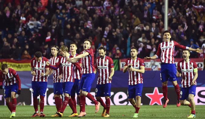 Atletico de Madrid players celebrate winning during the UEFA Champions League last sixteen second leg football match Club Atletico de Madrid vs PSV Eindhoven at the Vicente Calderon stadium in Madrid. Pic/AFP