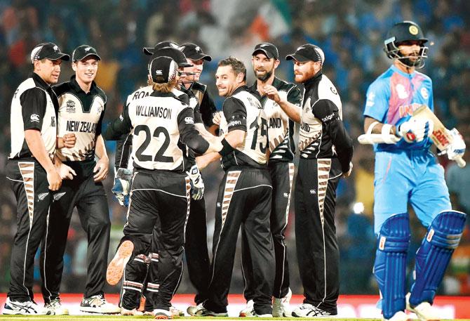 New Zealand spinner Nathan McCullum (fourth from right) celebrates with teammates the wicket of India opener Shikhar Dhawan in Nagpur on Tuesday. Pic/AFP