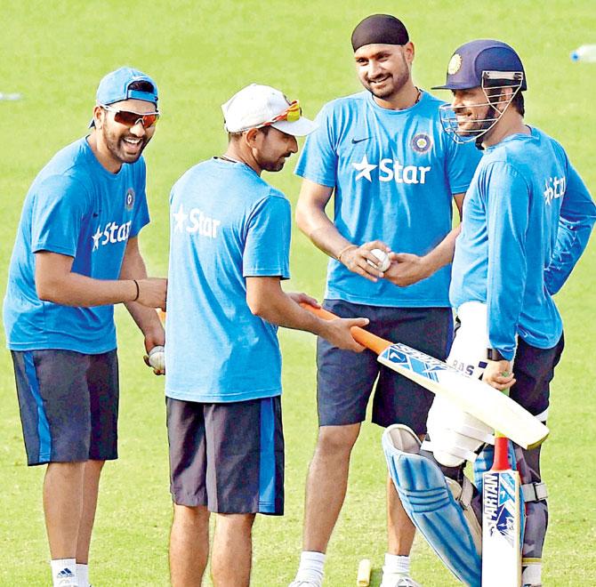 India skipper MS Dhoni (right), Harbhajan Singh, Mohammed Shami and Rohit Sharma (left) share a light moment during a practice session at Eden Gardens in Kolkata yesterday