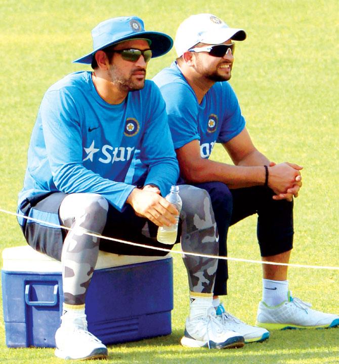 India skipper MS Dhoni (left) and teammate Suresh Raina take a breather during a training session on the eve of their match against Pakistan at Kolkata