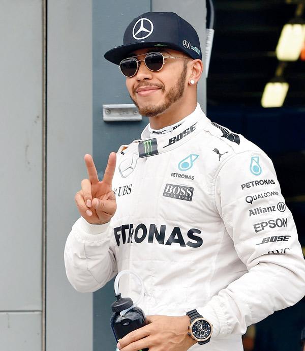 Mercedes driver Lewis Hamilton celebrates after taking pole position during the Australian GP in Melbourne on Saturday. pic/AFP
