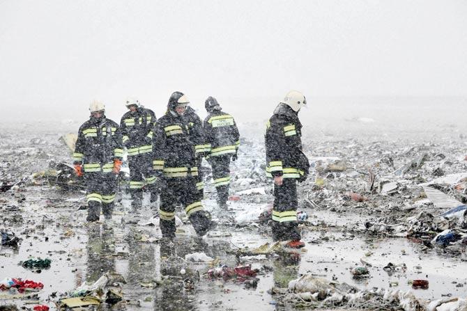 Russian Emergency Ministry employees are seen among the wreckage of a crashed plane at the Rostov-on-Don airport on Saturday. Pic/PTI