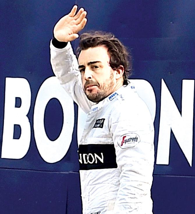 The Spaniard waves to fans after the accident