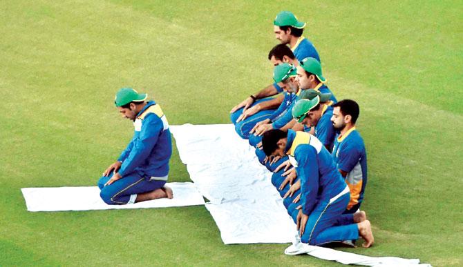 Seeking divine intervention: Pakistani players say their evening prayers at the PCA Stadium in Mohali yesterday. Pic/PTI