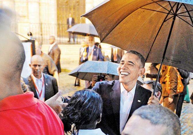 US President Barack Obama talks to tourists and Cubans at his arrival to the Havana Cathedral. Pic/AFP