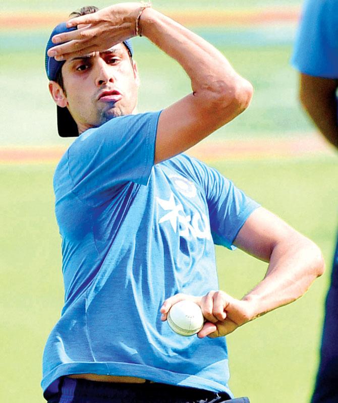 Ashish Nehra bowls in the nets at Bangalore yesterday. Pic/PTI