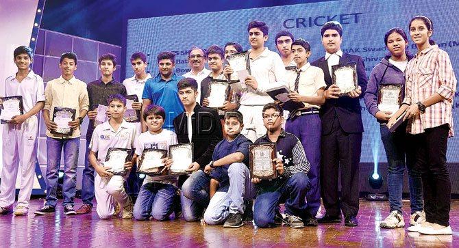 Cricketers display their awards during the ceremony