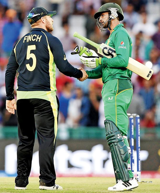 Australia’s Aaron Finch shakes hands with Pakistan’s Shoaib Malik at the completion of yesterday’s game at the Punjab Cricket Association ground in Mohali. Pic/AFP