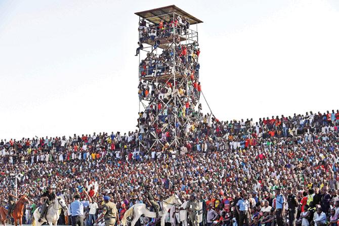 Fans climb a floodlight tower to watch the African Cup of Nations qualification match between Egypt and Nigeria in Kaduna, Nigeria  on Friday. pic/AFP 