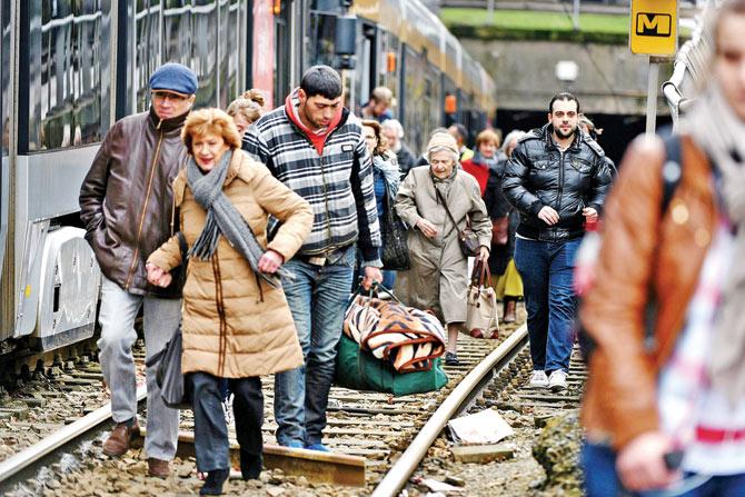 People evacuate a tram in the Schaerbeek-Schaarbeel district in Brussels on Friday. pic/afp