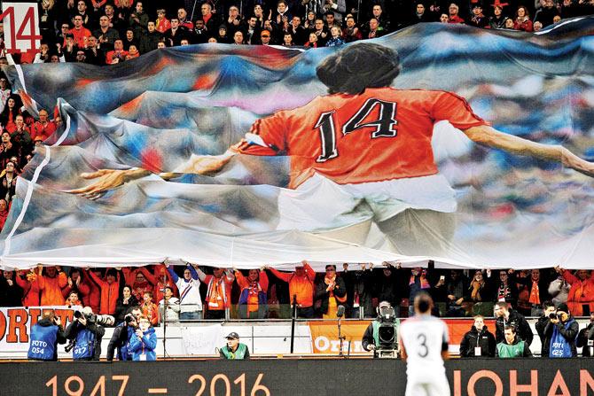 A large banner is displayed in honour of late Dutch legend Johan Cruyff during a tribute in the 14th minute of the friendly match between the Netherlands and France at Amsterdam Arena in Amsterdam on Friday.  pic/AFP