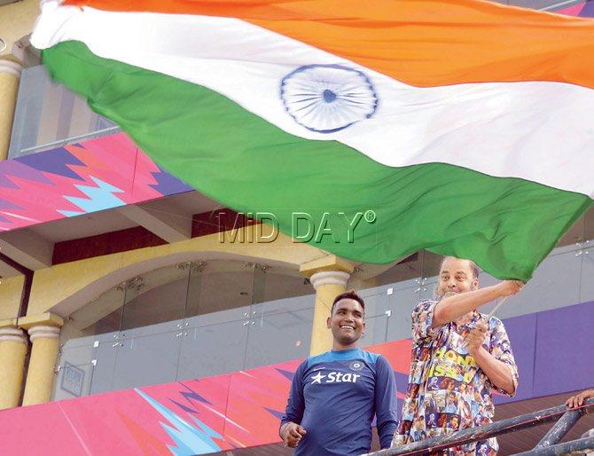 Pakistani chacha Bashir Ahmed (right) waves the Indian flag at the Punjab Cricket Association Stadium in Mohali on Saturday. Pic/Harit N Joshi 