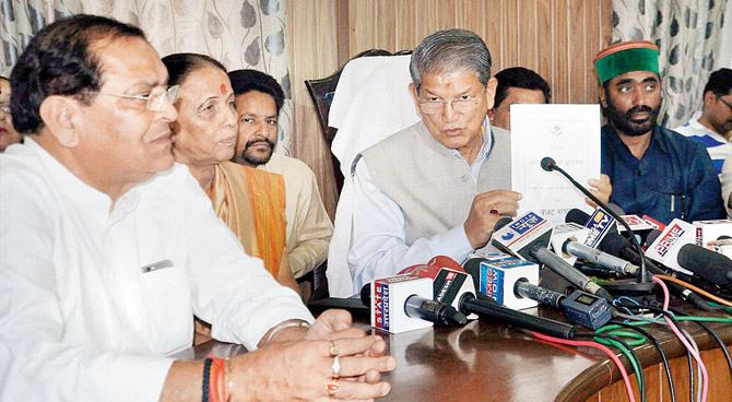 Former Uttarakhand Chief Minister Harish Rawat showing a copy of his government’s budget in Dehradun on Tuesday. PIC/PTI