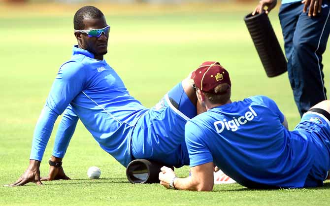 West Indies cricket team captain Darren Sammy (L) warms up during the training session at the Cricket Club of India stadium in Mumbai. Pic/AFP