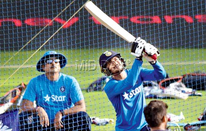Manish Pandey bats as Team India Director Ravi Shastri looks on during a practice session at Wankhede Stadium yesterday. Pic/Atul Kamble