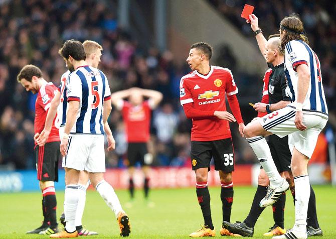 Red sees red: Referee Mike Dean shows the red card to Manchester United