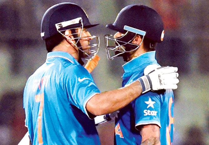 Skipper MS Dhoni (left) and Virat Kohli greet each other after India