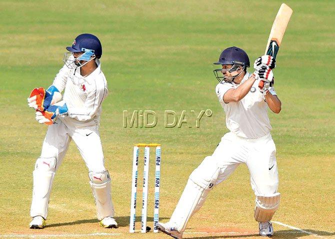 Karun Nair of Rest of India cuts away during his 192-ball 94 as Mumbai captain and wicketkeeper Aditya Tare follows the direction of the ball on Day Three of the Irani Cup encounter at the Brabourne Stadium yesterday. Pic/Suresh Karkera