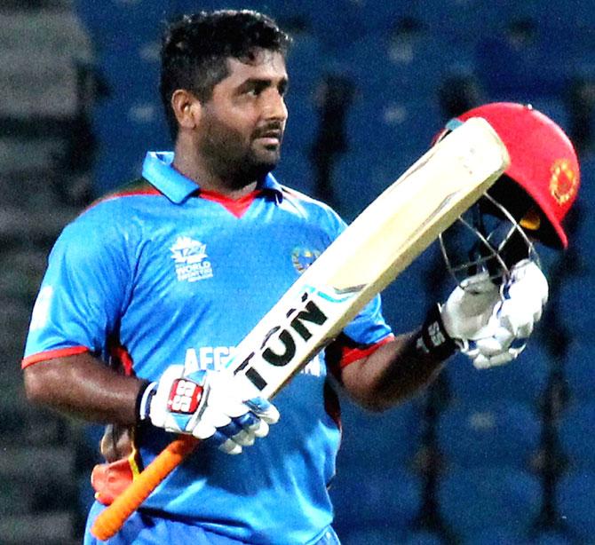 Afghanistan batsman Shahzad Mohammadi lifts his bat afier completing his half century against Scotland during thier ICC T20 World cup match in Nagpur. Pic/PTI