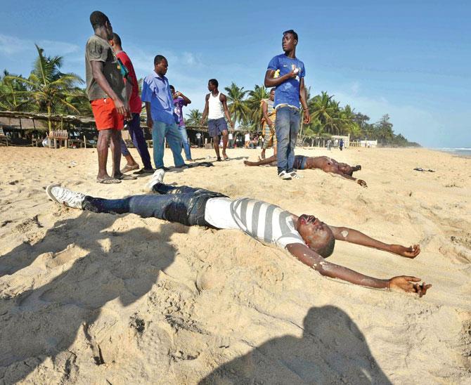 Bodies lie on the beach after the armed attack at Ivory Coast. Pic/AFP