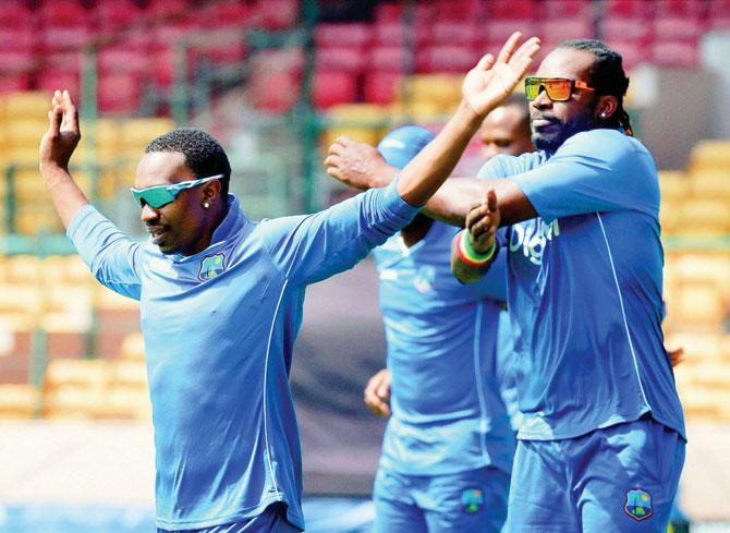 Windies’ Dwayne Bravo (left) and Chris Gayle train during a practice session at the M Chinnaswamy Stadium in Bangalore on Saturday. pic/PTI 