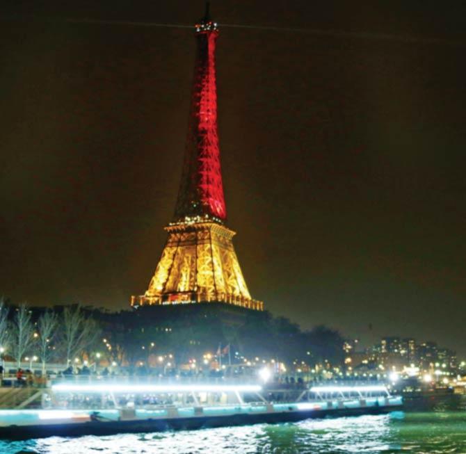The Eiffel Tower illuminated in colours of the Belgian flag in tribute to the victims of terrorist attacks in Brussels. Pic/AFP