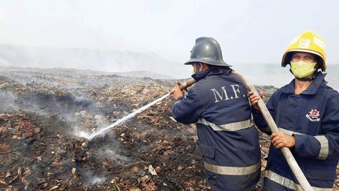 Firefighters douse the massive fire at the Deonar dumping ground on February 1