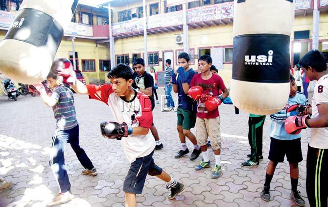 The 30 students share four pairs of boxing gloves donated by NGOs. They make the most of what they have, says their coach