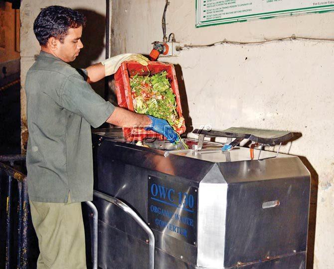 A staffer adds the daily waste to the Organic Waste Converter facility at ITC Grand Central, Parel. Pic/Datta Kumbhar