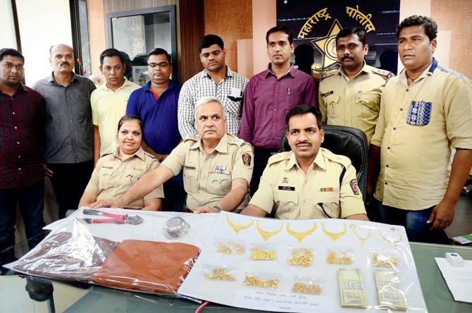 Bowled the thieves over: The police officers who solved the case, seen here with the steel bowl, recovered jewellery and money. Also seen are (sitting extreme left) Police Inspector Sangeeta Alphonso Shinde and (sitting extreme right) Shahaji Umap, deputy police commissioner, Navi Mumbai