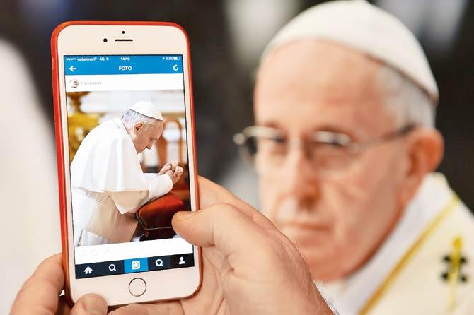 A man looks at the Instagram account of Pope Francis (Franciscus). The Pope is expanding his presence on social media with an Instagram account. The pontiff, who has more than 26 million followers on his Twitter account, launched his own account on Instagram on March 19, 2016. The Pope’s account uses @Franciscus, his name in Latin. Pic/AFP