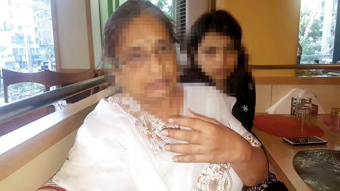 The 58-year-old woman and her daughter (right) were locked in a property dispute. The mother was on her way home to fetch her son-in-law to read a document when the accused attacked her