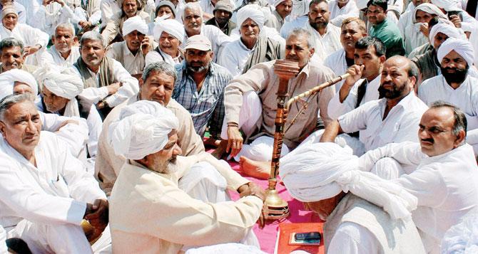 Calm before the storm? Members of Jat community during a peaceful daylong protest in Rohtak on Monday. Pic/PTI