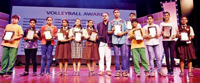 SHARP SPIKERS: Volleyball players display their awards during the ceremony